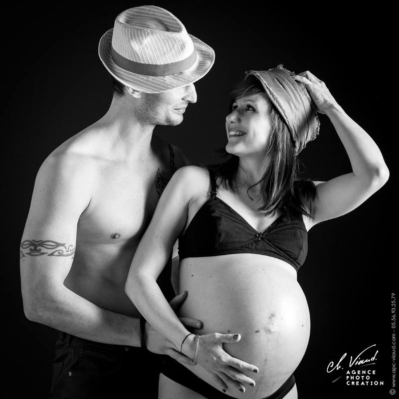 Portrait d'un couple avec des chapeaux en noir et blanc avant la naissance de leurs bébé